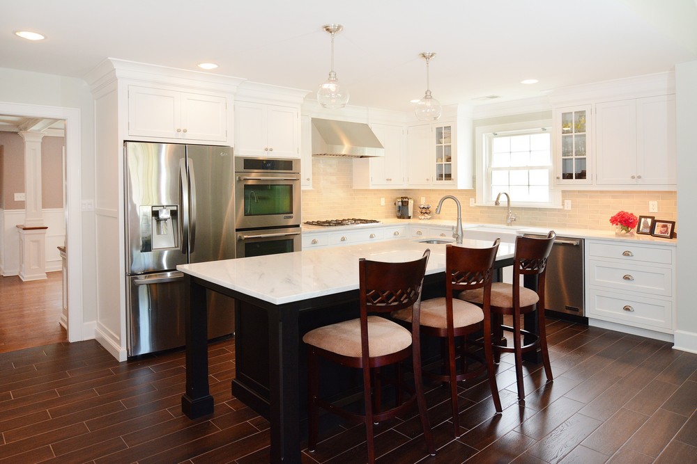 Modern white kitchen renovation in Northern NJ with island seating, quartz countertops, and custom cabinetry
